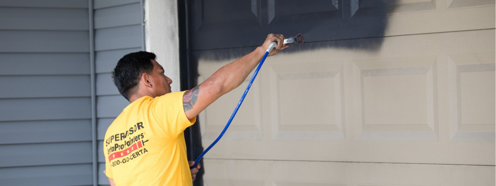 certapro painter in progress of garage painting